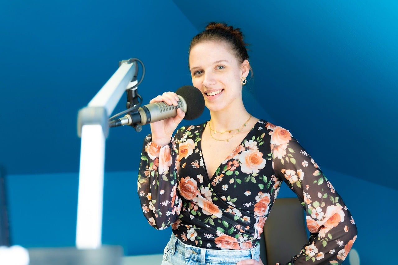 Starting a Podcast Woman Wearing Flower Blouse Holding Microphone